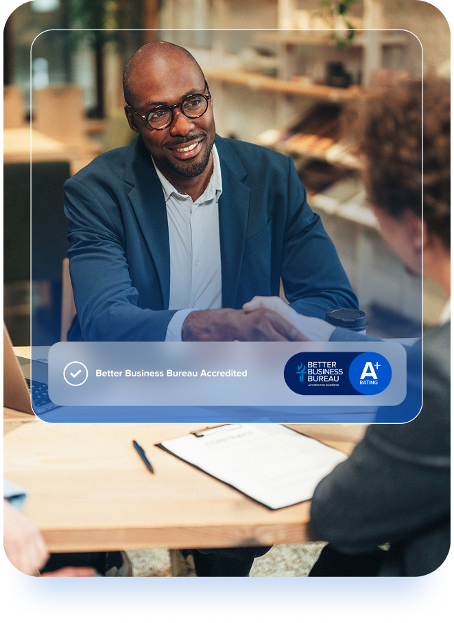 Financial professional shaking hands with a client across a desk